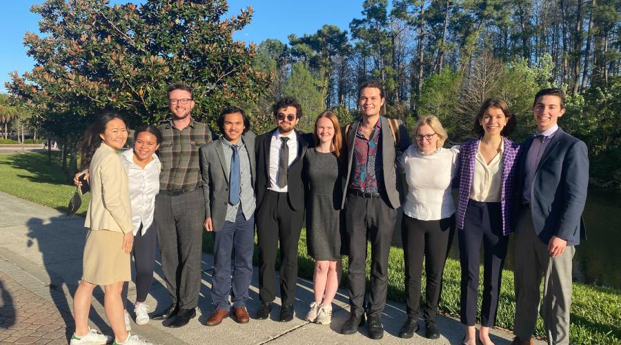 Members of the Cornell Speech program pose in suits before the tournament