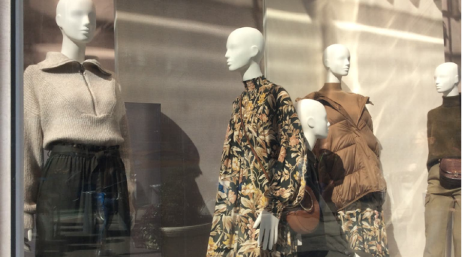 3 mannequins in a storefront window