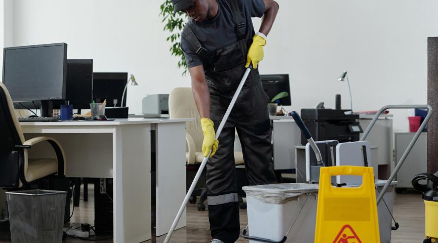A janitor working after hours in an office. 