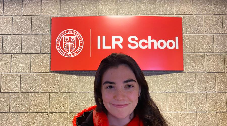 Callie Burns smiling in front of ILR sign
