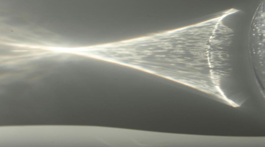 Image of lens effect producing a cone of light with the appearance of three dimensional depth