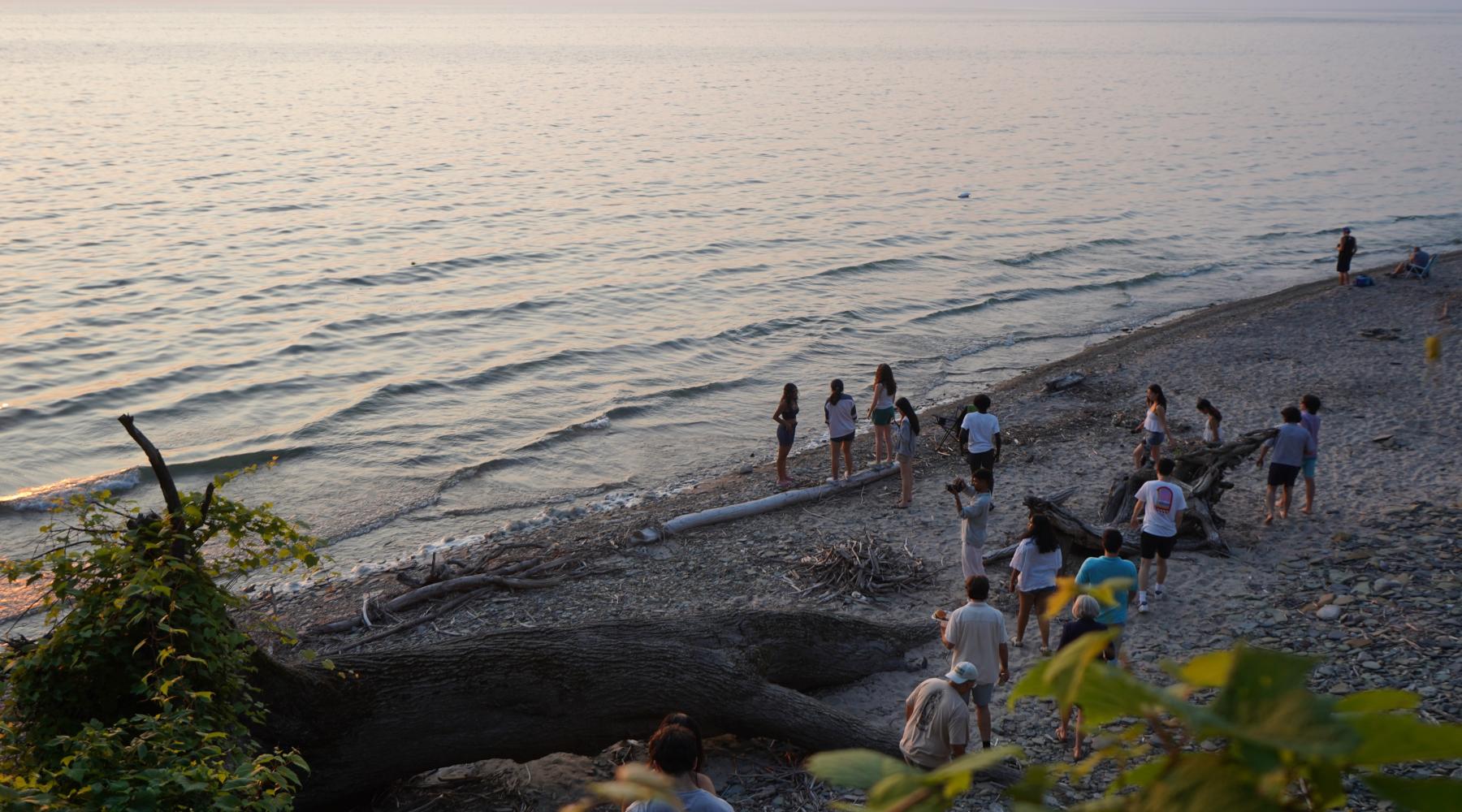 Buffalo High Road students at the beach, walking along the shore