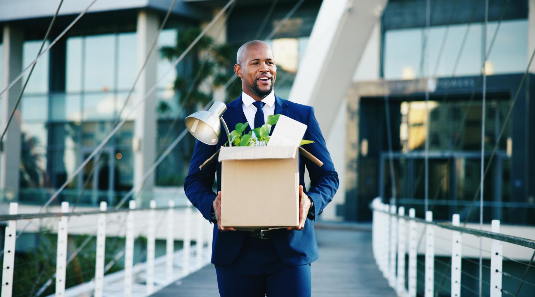 employee leaving with box of belongings