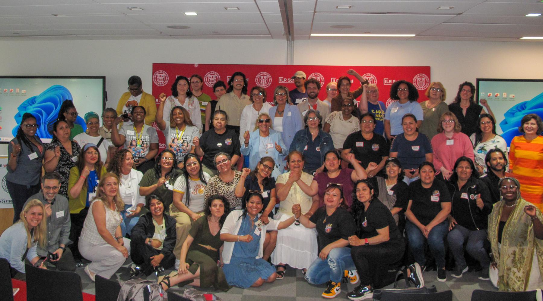 Group of approximately 50 people posing for a group shot and smiling