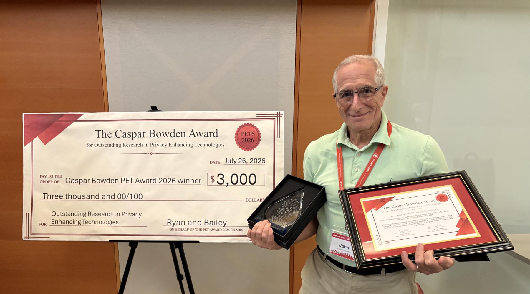 John Abowd poses with the 2026 Caspar Bowden PET Award for Outstanding Research in Privacy Enhancing Technologies