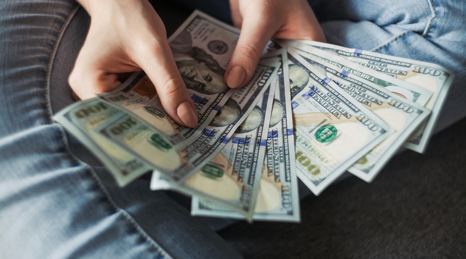 Girl holding American Dollar Bills