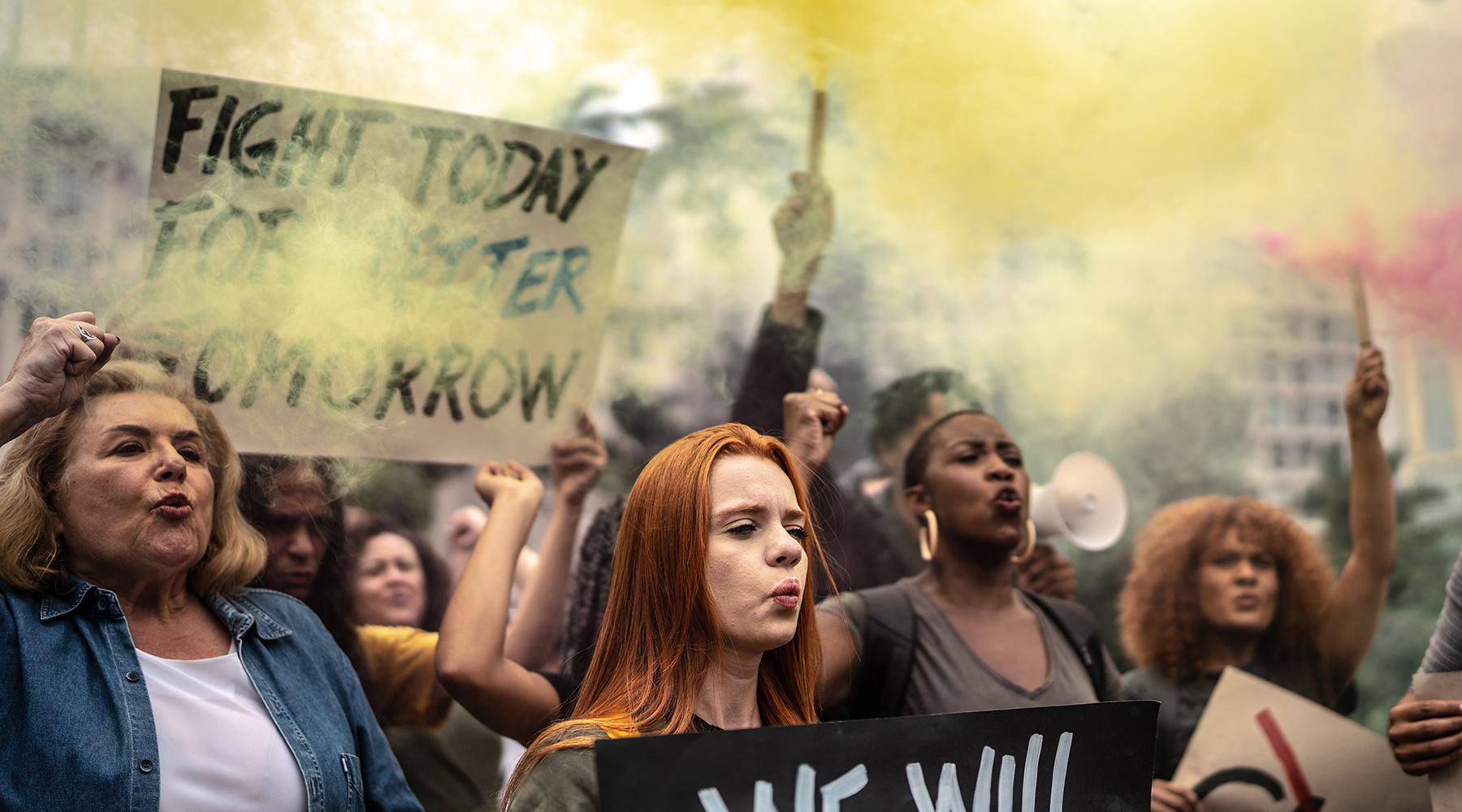 Protesters holding signs during a demonstration in the street