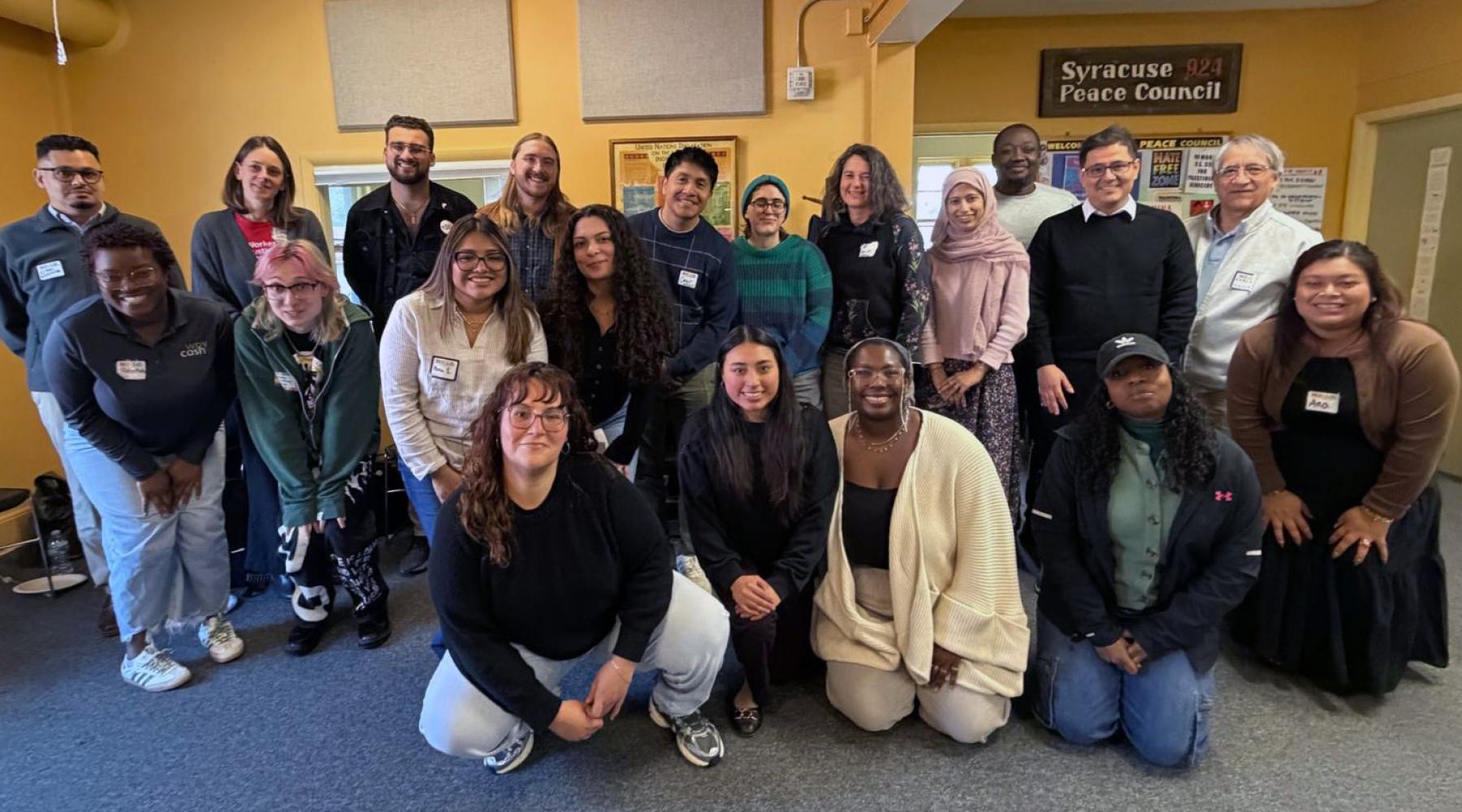 Mix group of men and women posing and smiling for camera