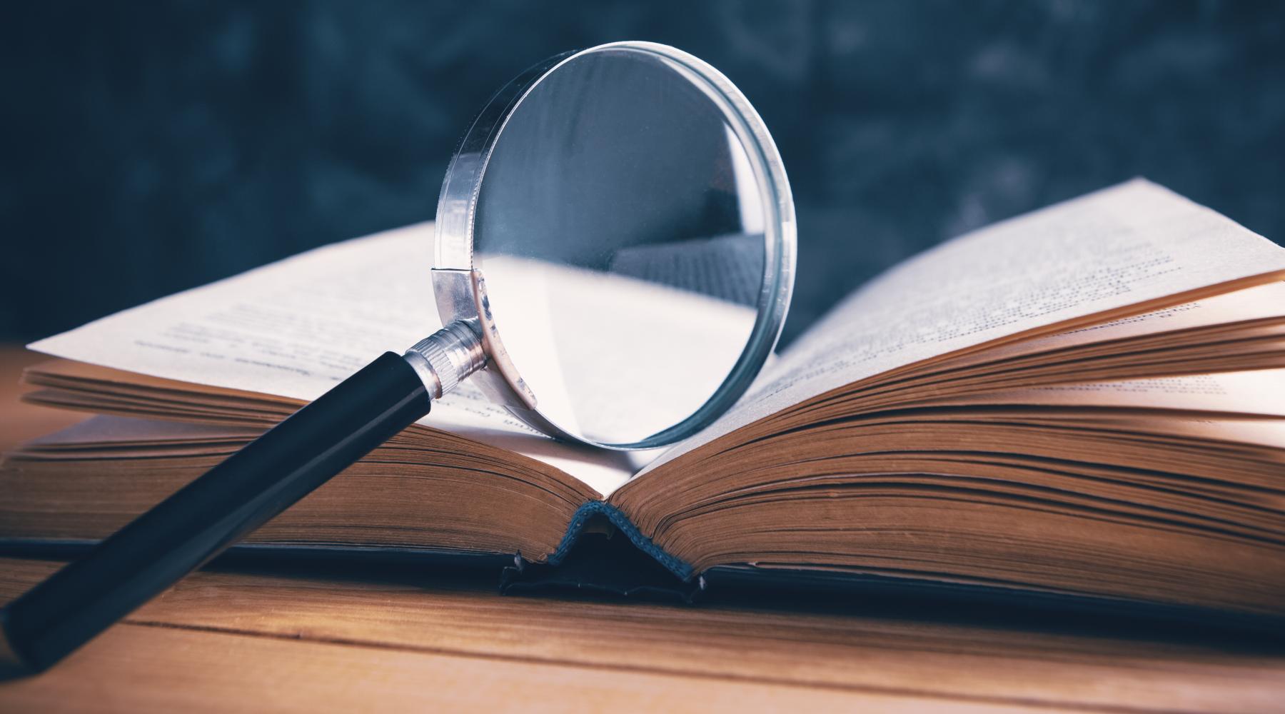 magnifying glass over a book 