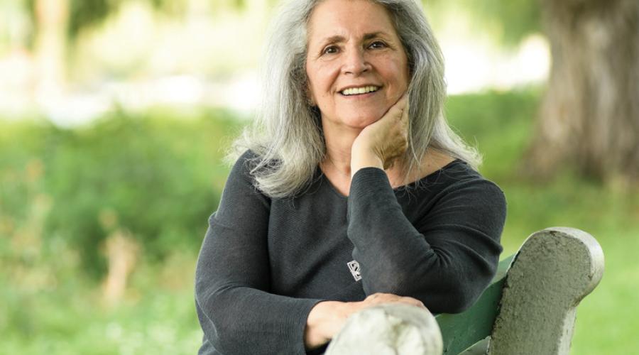 Marlene Blumin, CALS Ph.D. ’88 sitting on a park bench