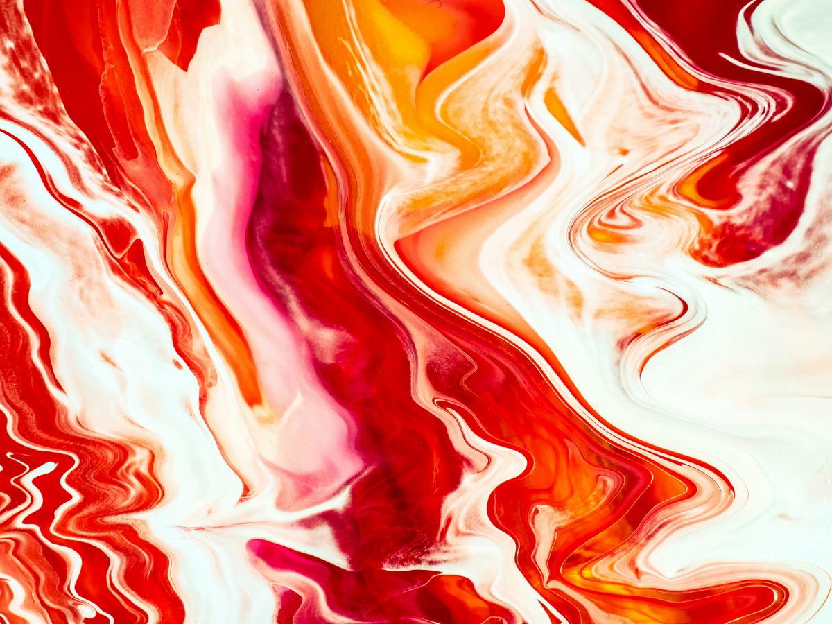 orange, red, and white paint splashed on canvas