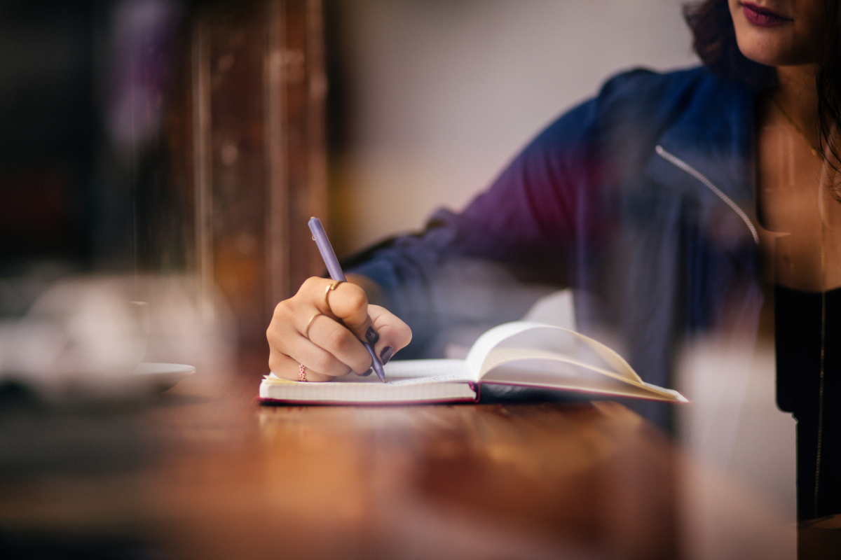 Person writing in journal