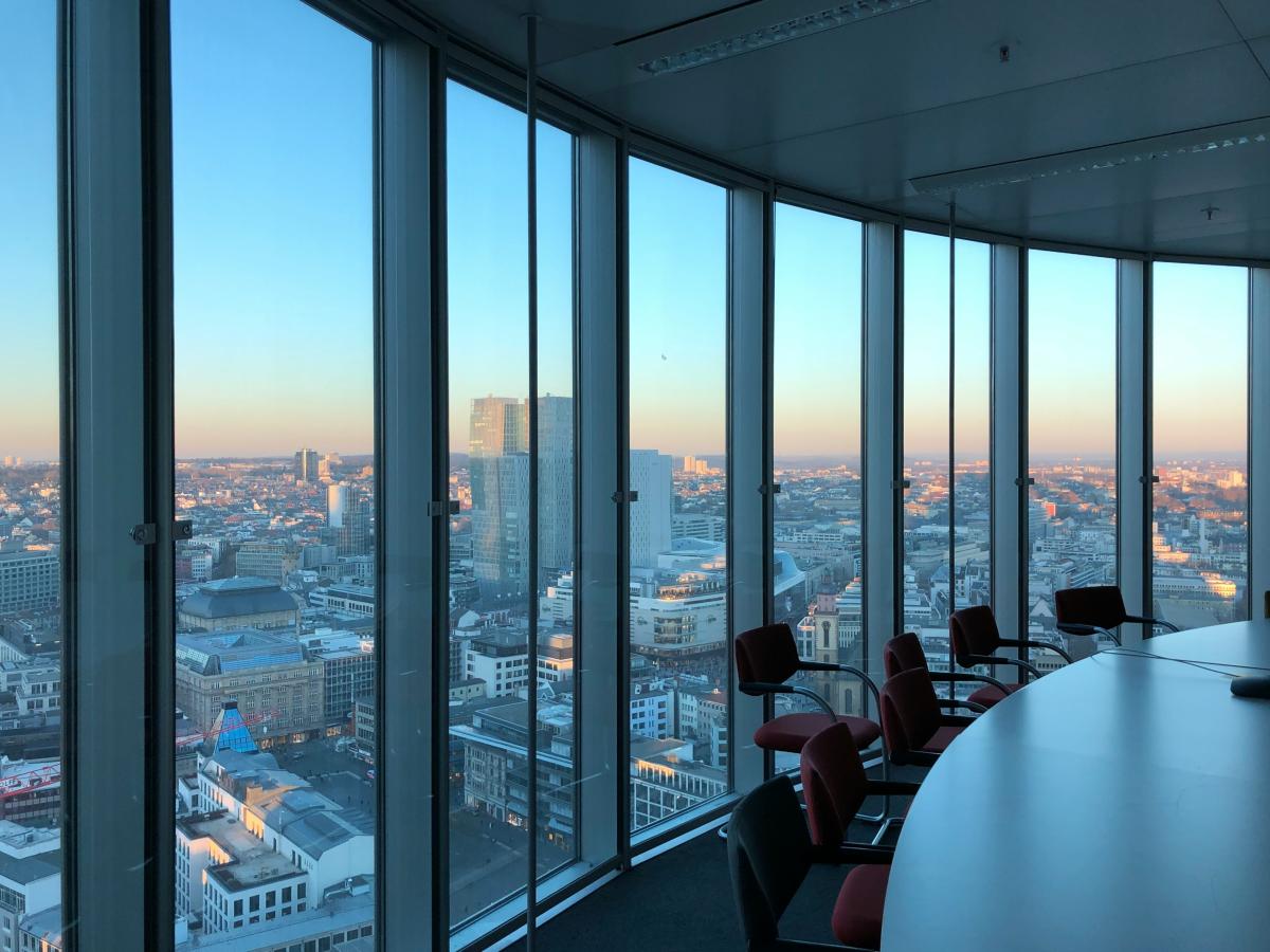 An image with executive boardroom window facing skyscraper office building
