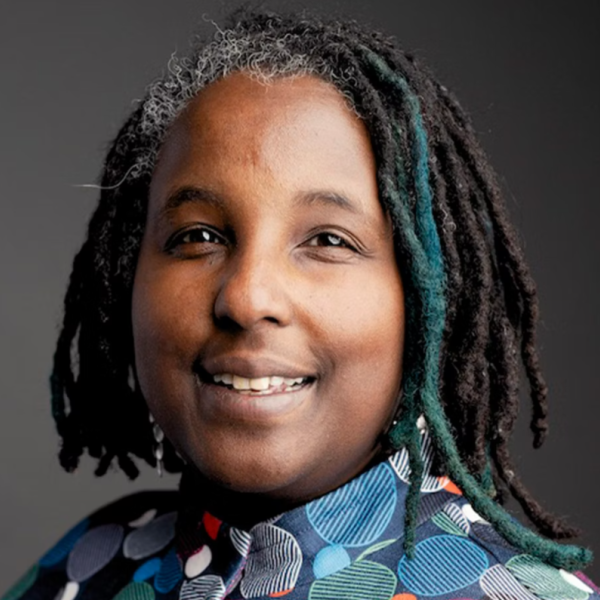 Professional woman with locks smiles at camera