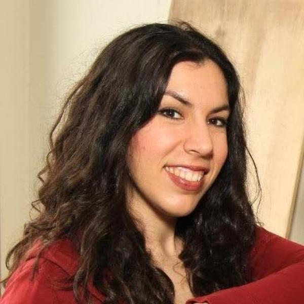 woman with dark hair smiles at camera