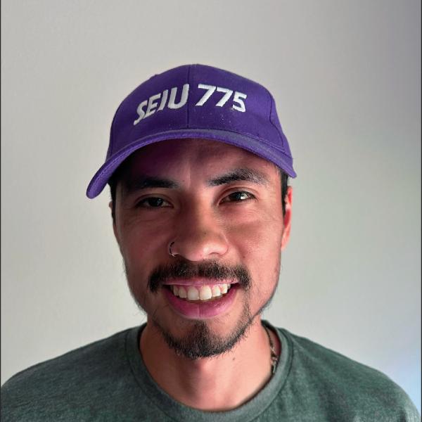 headshot of man wearing a purple SEIU hat