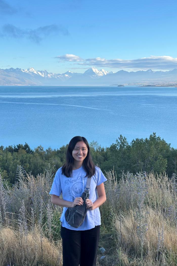 student outdoors with mountains in the distance