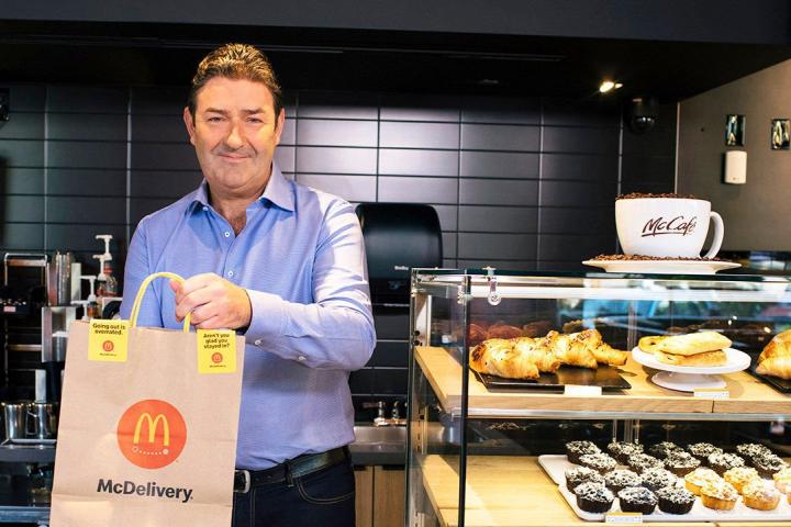 A McDonald's employee carrying a delivery bag