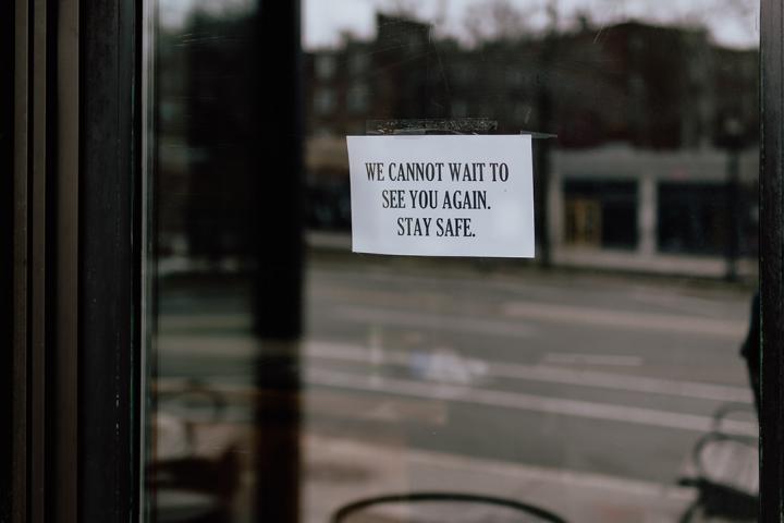 photo of a shop door with a note saying:"We cannot wait to see you again, stay safe."