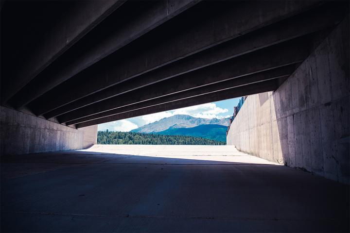 view of a mountain through a tunnel to illustrate the concept of emerging