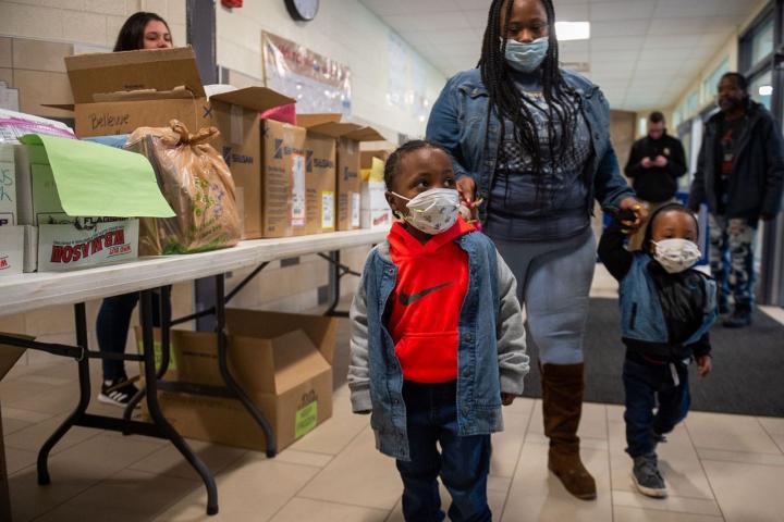 Noah Davis, 4, and his brother Able, 2, were among the children and parents that went to Bellevue Elementary School Tuesday, March 17, 2020 to pick up school lunches and homework as schools are closed in the Syracuse School District due to the coronavirus.N. Scott Trimble 