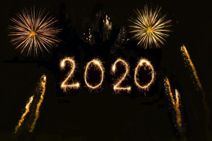 Fireworks and 2020 written in light across the night sky