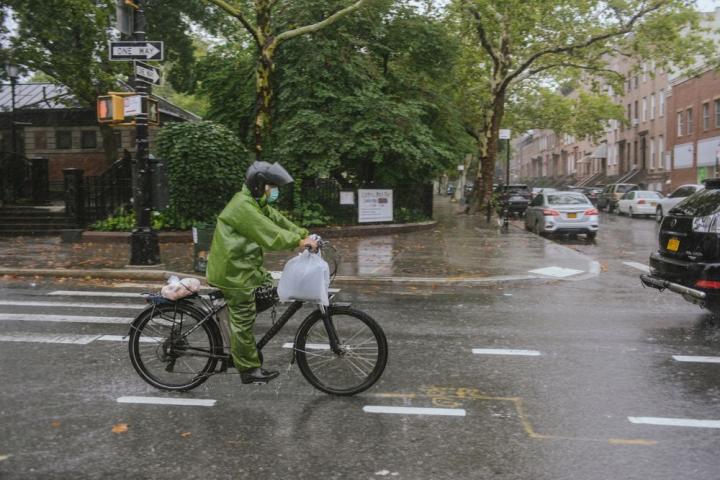 Delivery biker in New York City in the rain