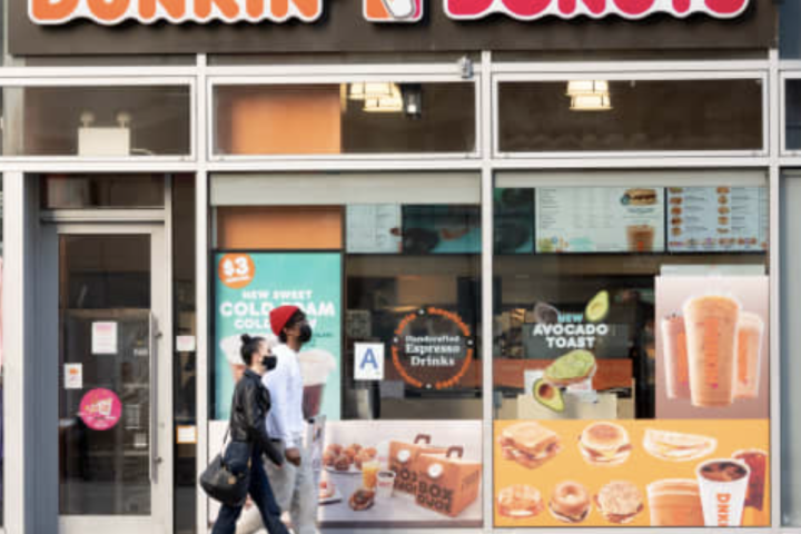 People walk outside Dunkin’ Donuts in New York City.Noam Galai | Getty Images Entertainment | Getty Images