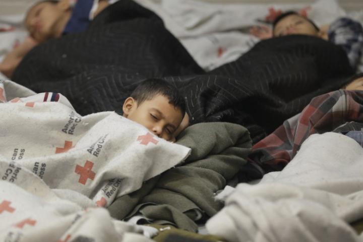 Refugees sleeping under Red Cross blankets