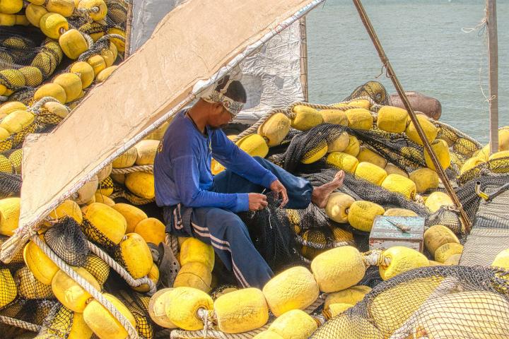 Philippine fisherman surrounded by buoys