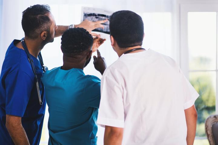 Doctors examining a medical photograph