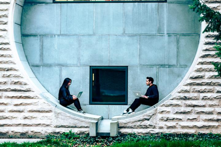 two undergraduate students sit in a circular window