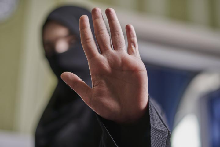 Muslim women raising hand