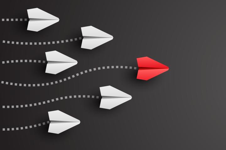 image showing red arrow in front of others leading the way