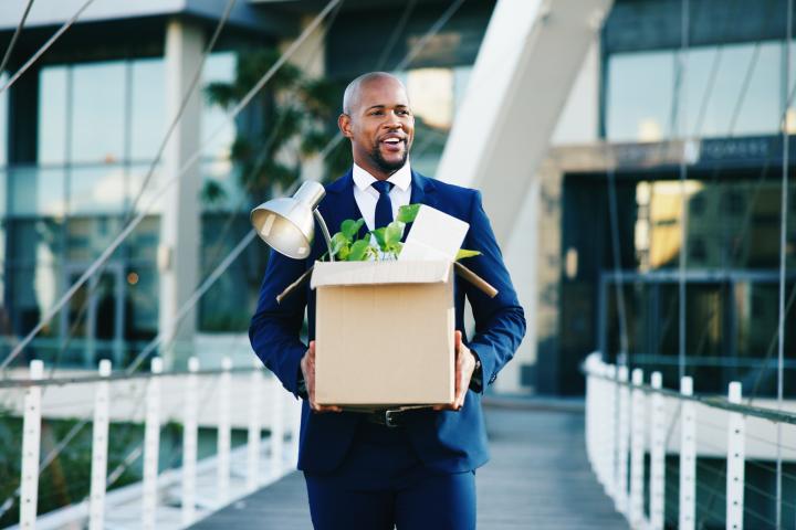 employee leaving with box of belongings