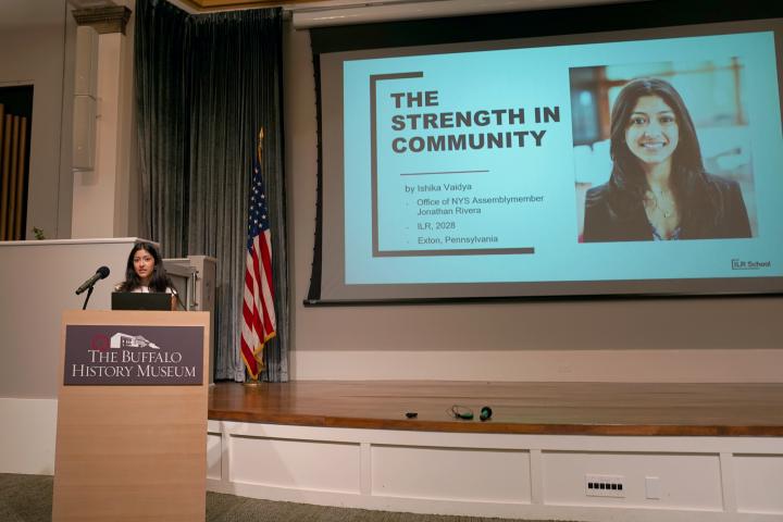 Ishika Vaidya speaking at a podium