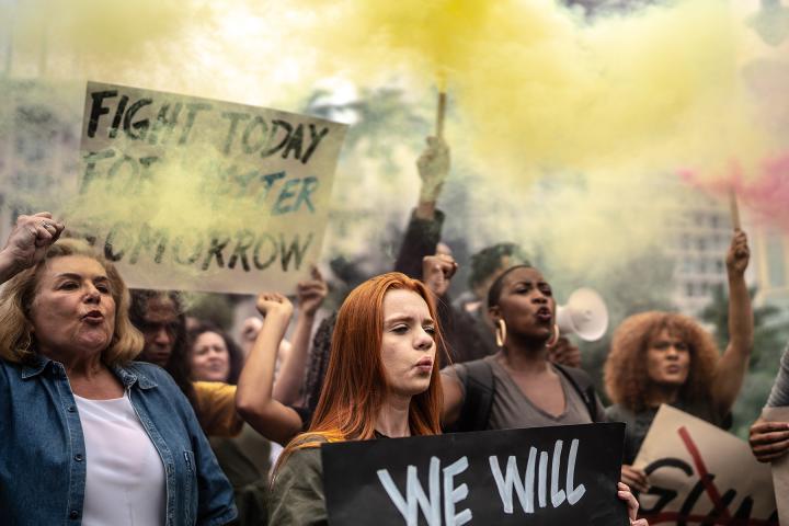Protesters holding signs during a demonstration in the street