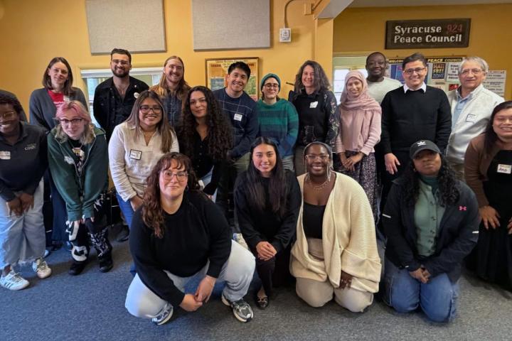 Mix group of men and women posing and smiling for camera