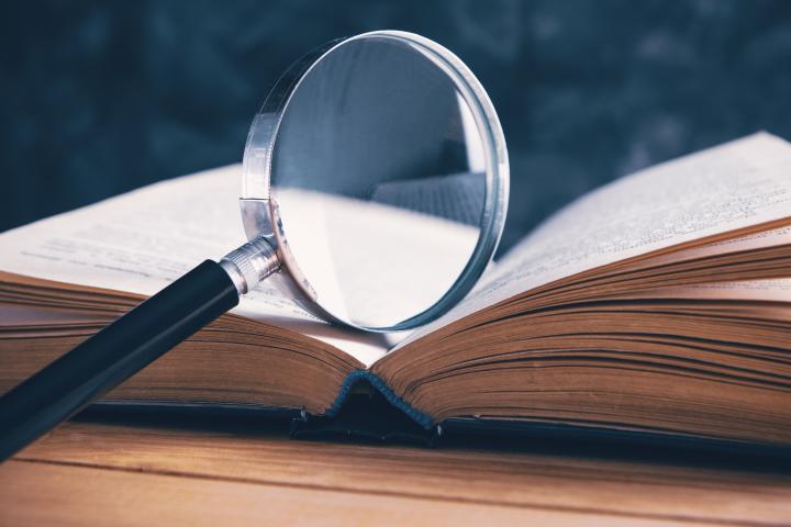 magnifying glass over a book 
