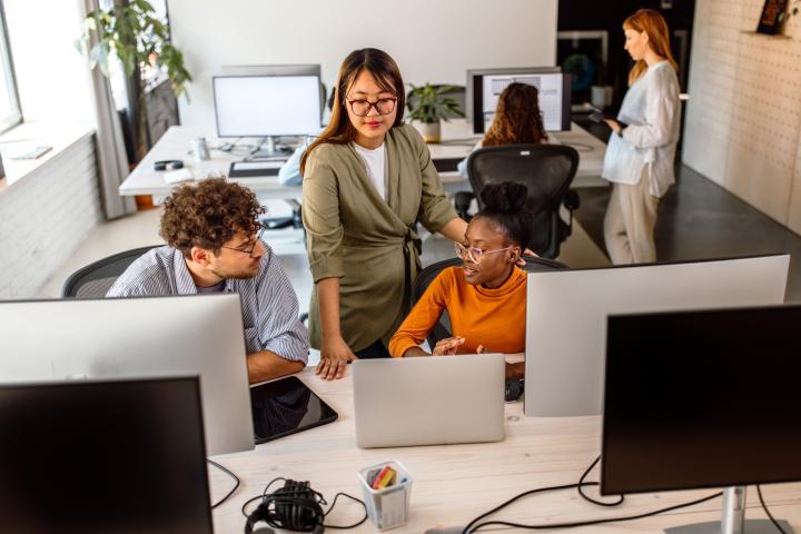 Office workers in an open plan desk area