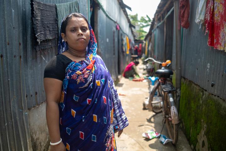 A southasian woman standing looking at camera