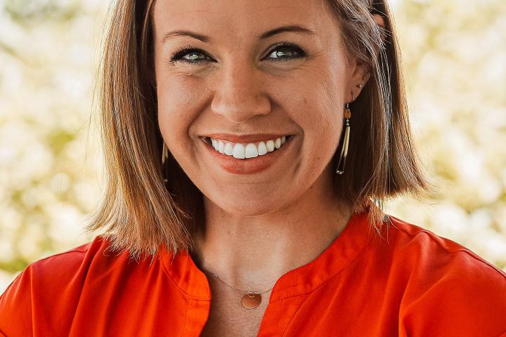 kricky headshot in orange shirt