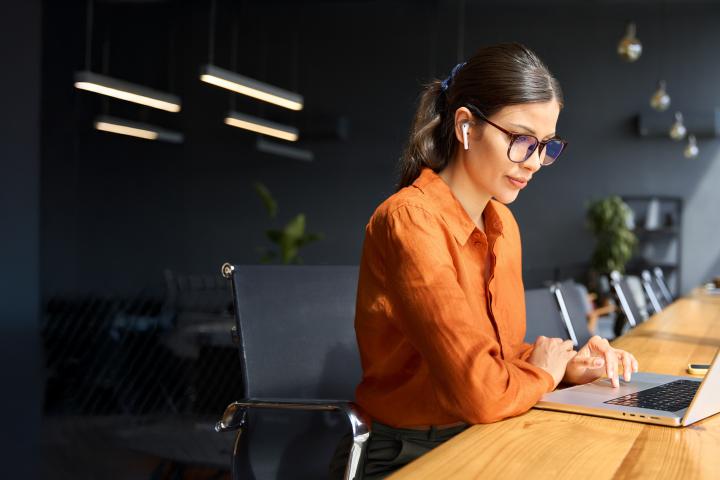 women listening to airpods representing learning 