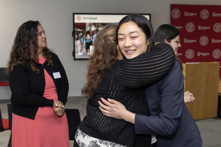 Woman hugging another woman while smiling