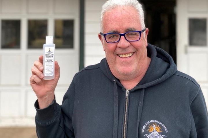 Raymond Disch ’80 with a bottle of hand sanitizer produced by his company, Sourland Mountain Spirits.