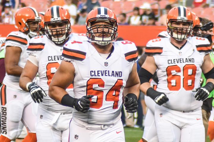 JC Tretter running on to the football field with Cleveland Brown teammates.