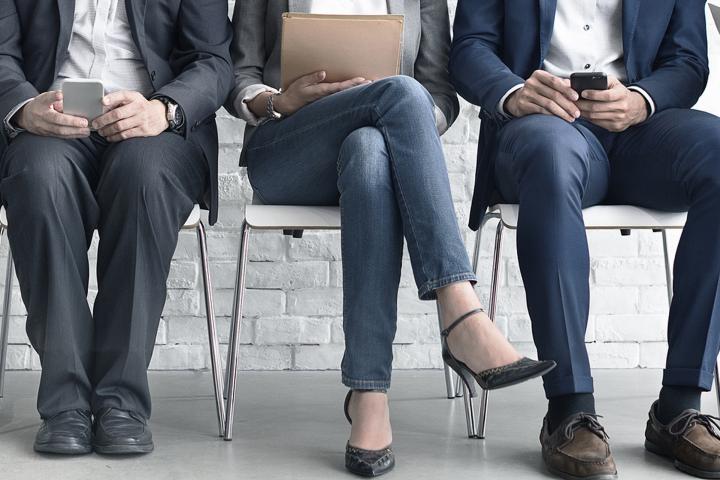Men and women wait for a job interview