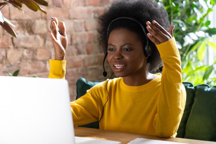 A young black women works remotely.