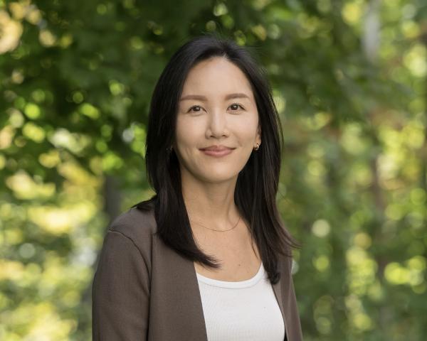 Image of a smiling woman with trees in the background