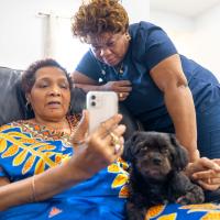 A home health aid and her patient on a telemedicine call